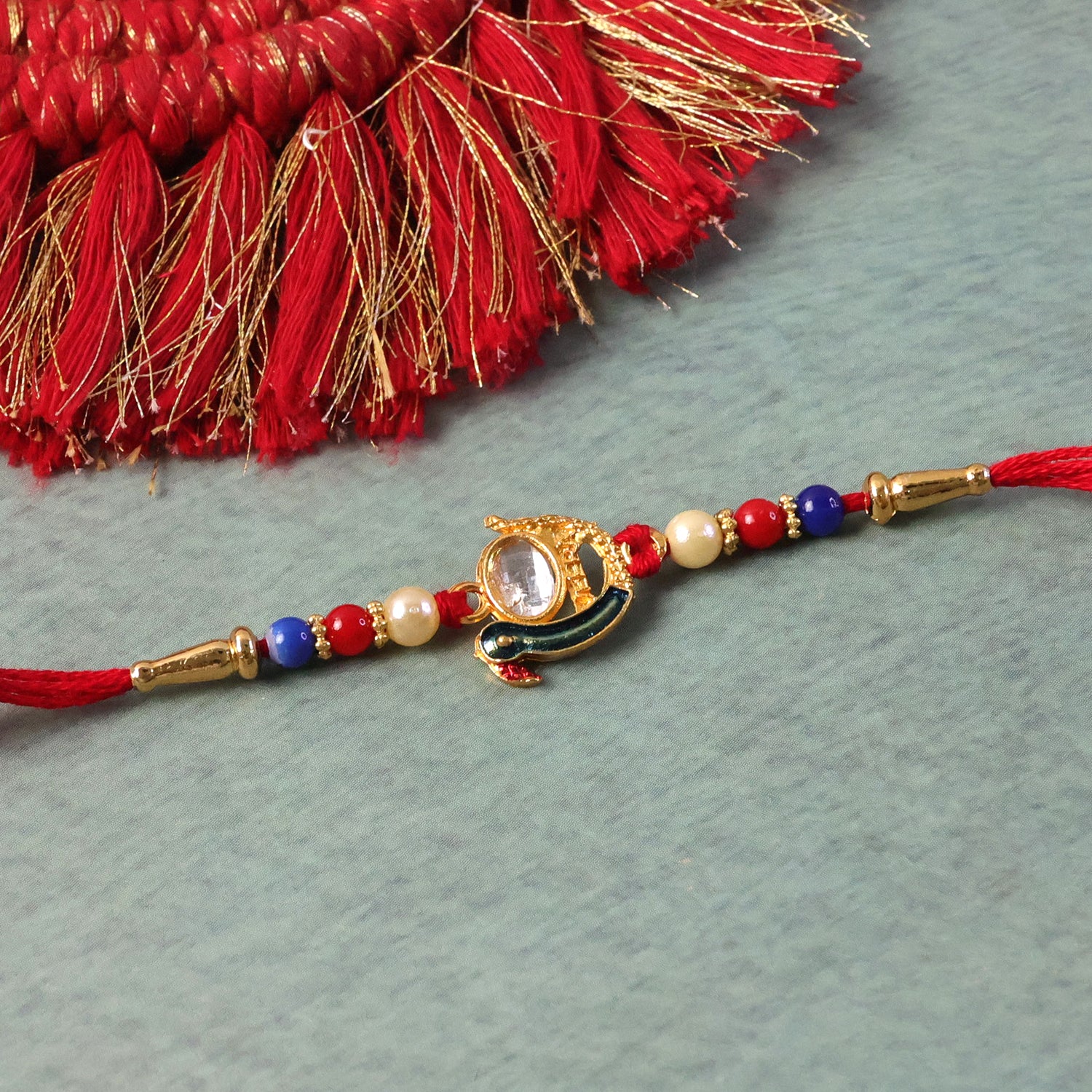 Elegant Stone Studded Designer Rakhi with Golden Finish Beads 1 Pc - Image 8