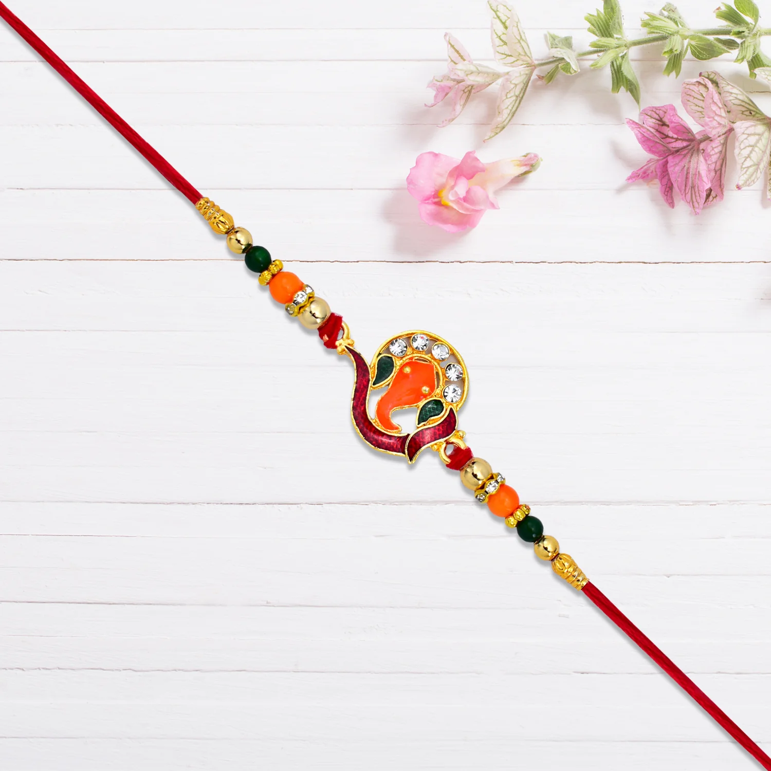 Golden Ganesha Rakhi with Red-Green Beads and Stone Detailing - Image 3