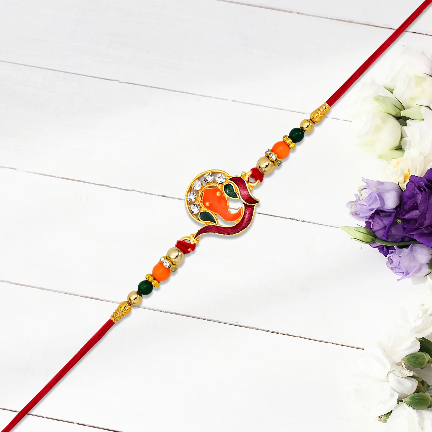 Golden Ganesha Rakhi with Red-Green Beads and Stone Detailing - Image 4