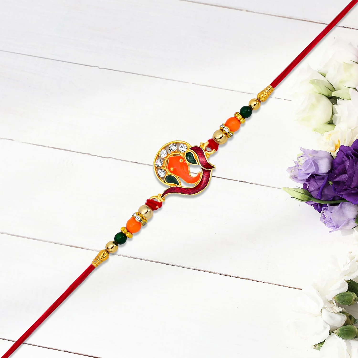 Golden Ganesha Rakhi with Red-Green Beads and Stone Detailing - Image 7