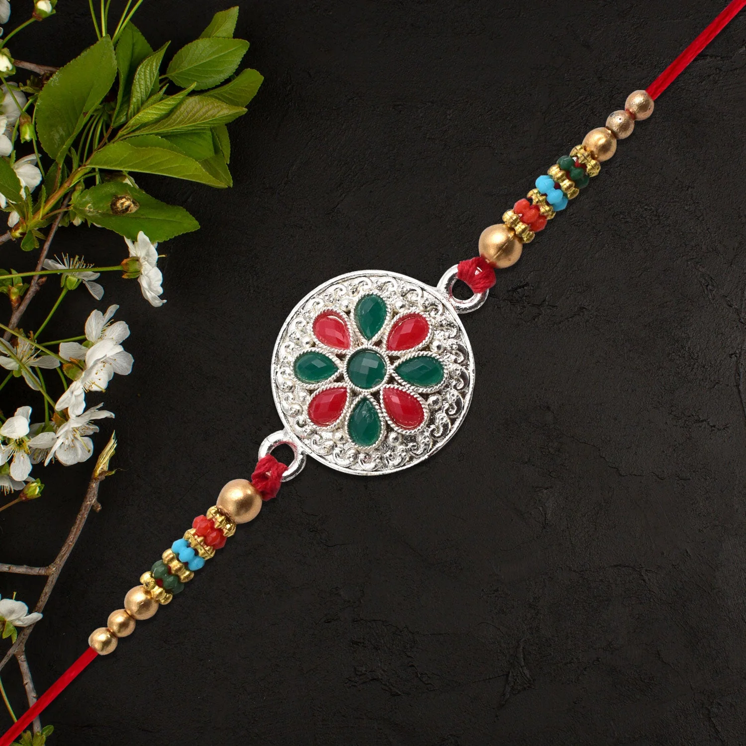 Silver Plated Floral Rakhi with Red & Green Stones - Image 4