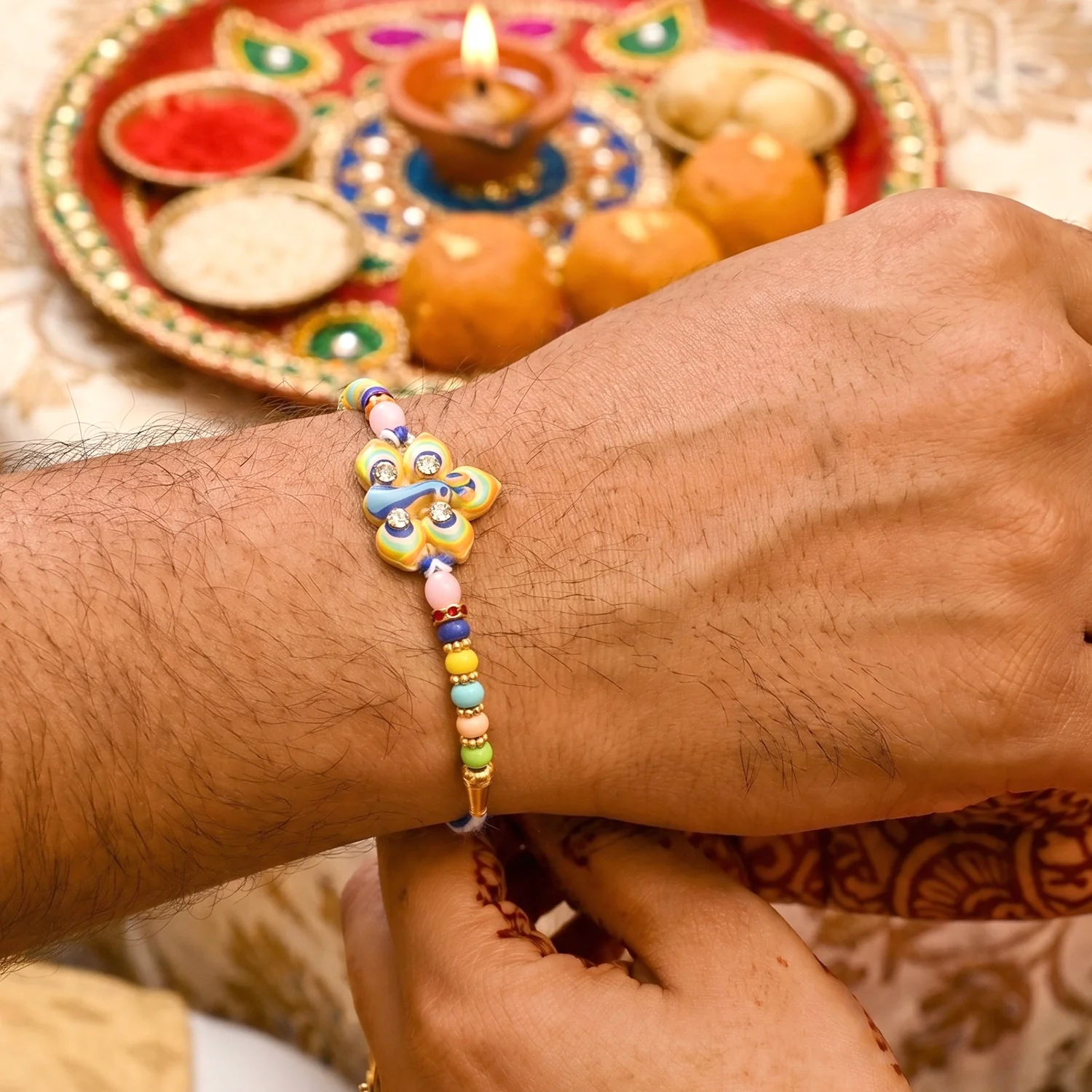 Stylized Peacock Feather Golden Swirl Rakhi - Image 2